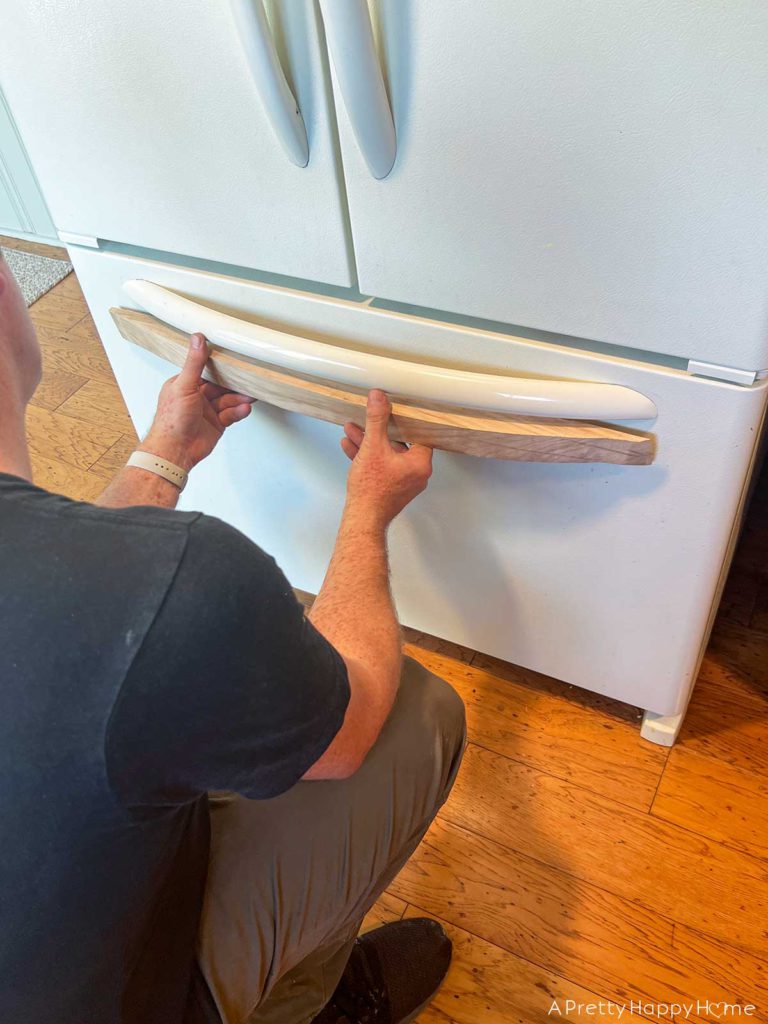 Building In Our Fridge: Four Ways To Customize A Fridge shaker style cabinet around fridge using tongue and groove construction. make curved wood handles for a refrigerator