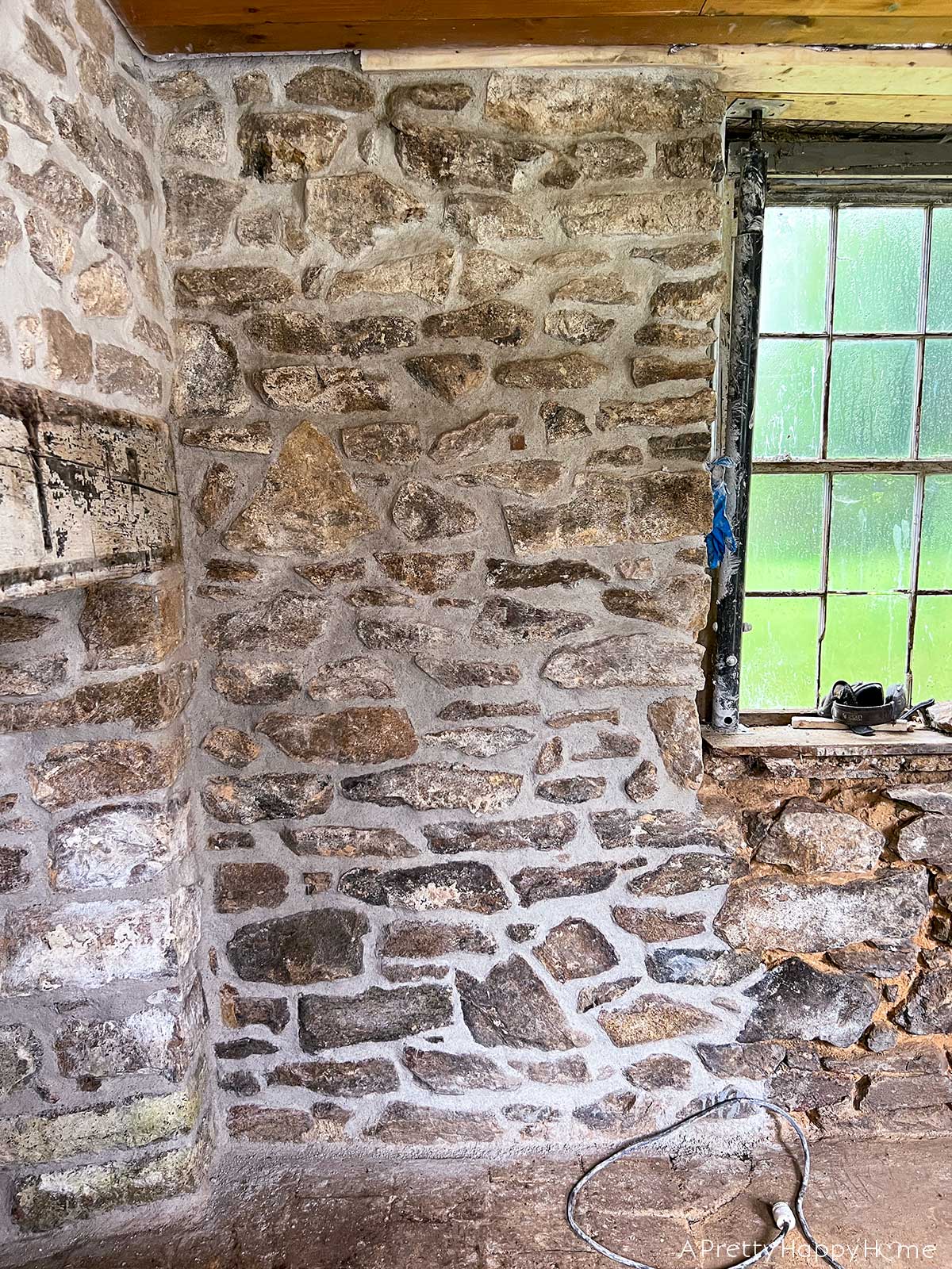 Wood In a Stone Wall wood embedded in a stone wall to give a place to hang things