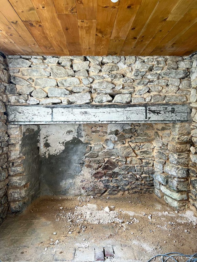 before photo of a fireplace in a 250 year old carriage house that will be an european inspired home gym