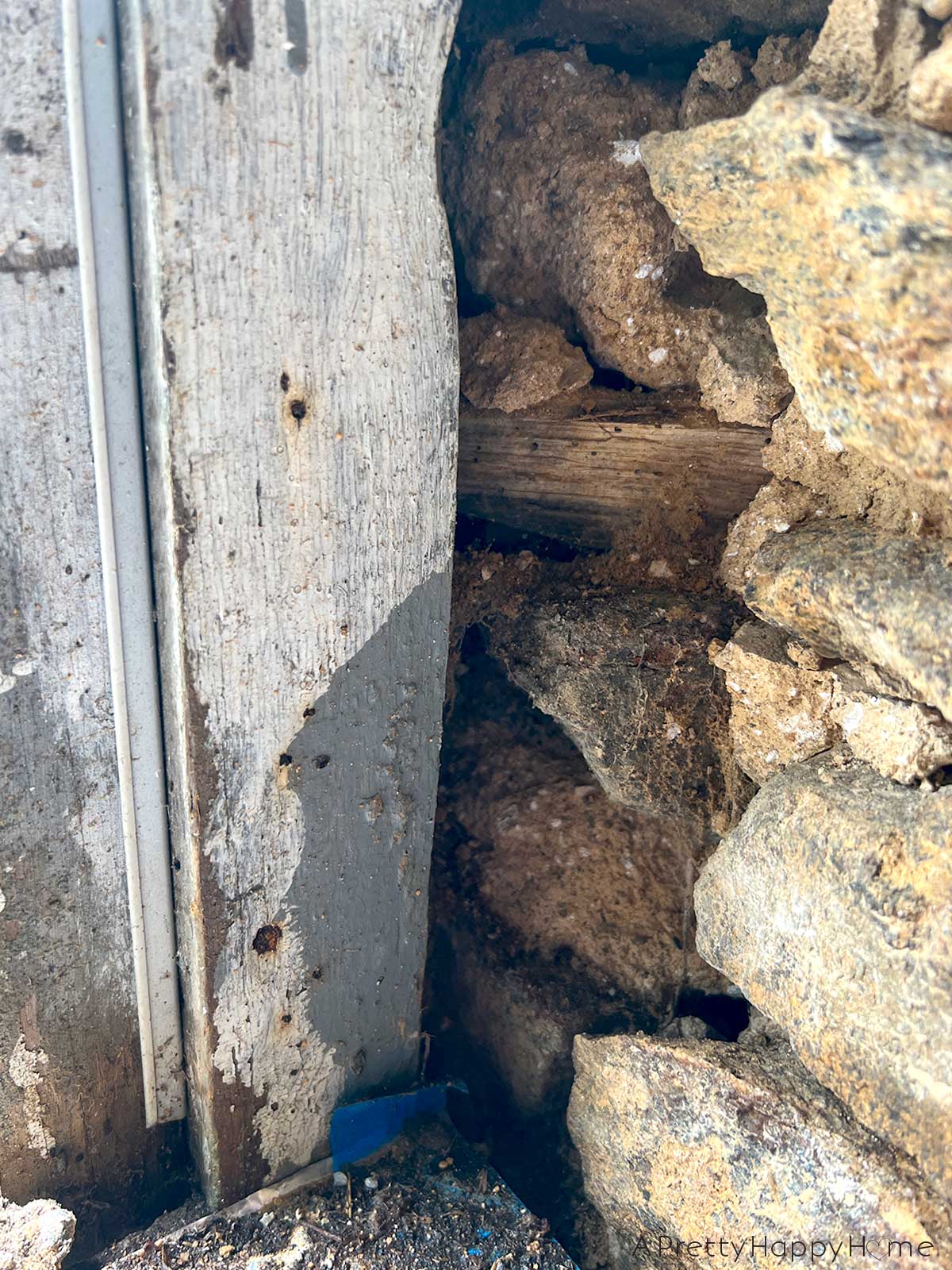 Wood In a Stone Wall diagonal pieces of wood embedded in an old stone wall to attach a window frame