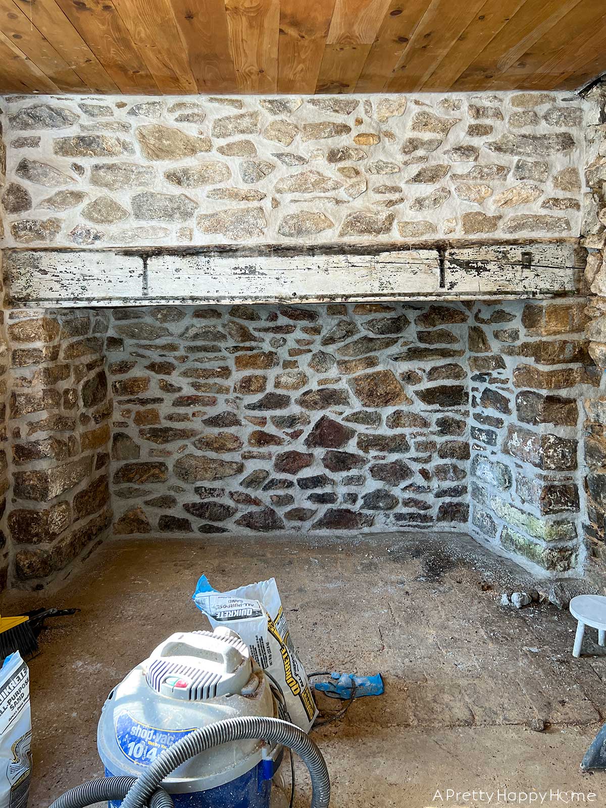 Wood In a Stone Wall wood mantel on a stone fireplace