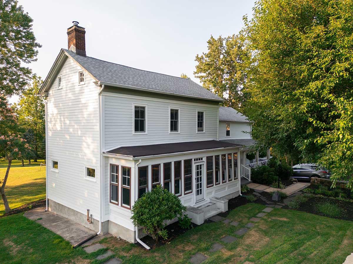 white colonial farmhouse exterior with sunporch