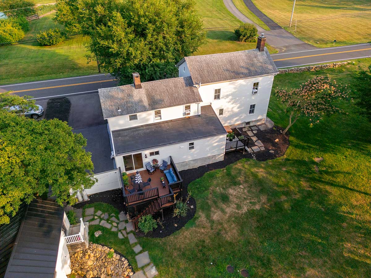 white colonial farmhouse exterior with sunporch