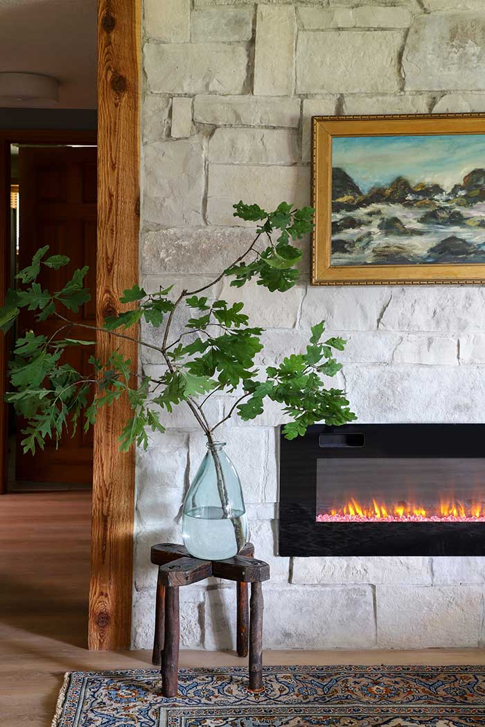 i spy diy makeover of lake den with electric fireplace and vintage stool on the happy list