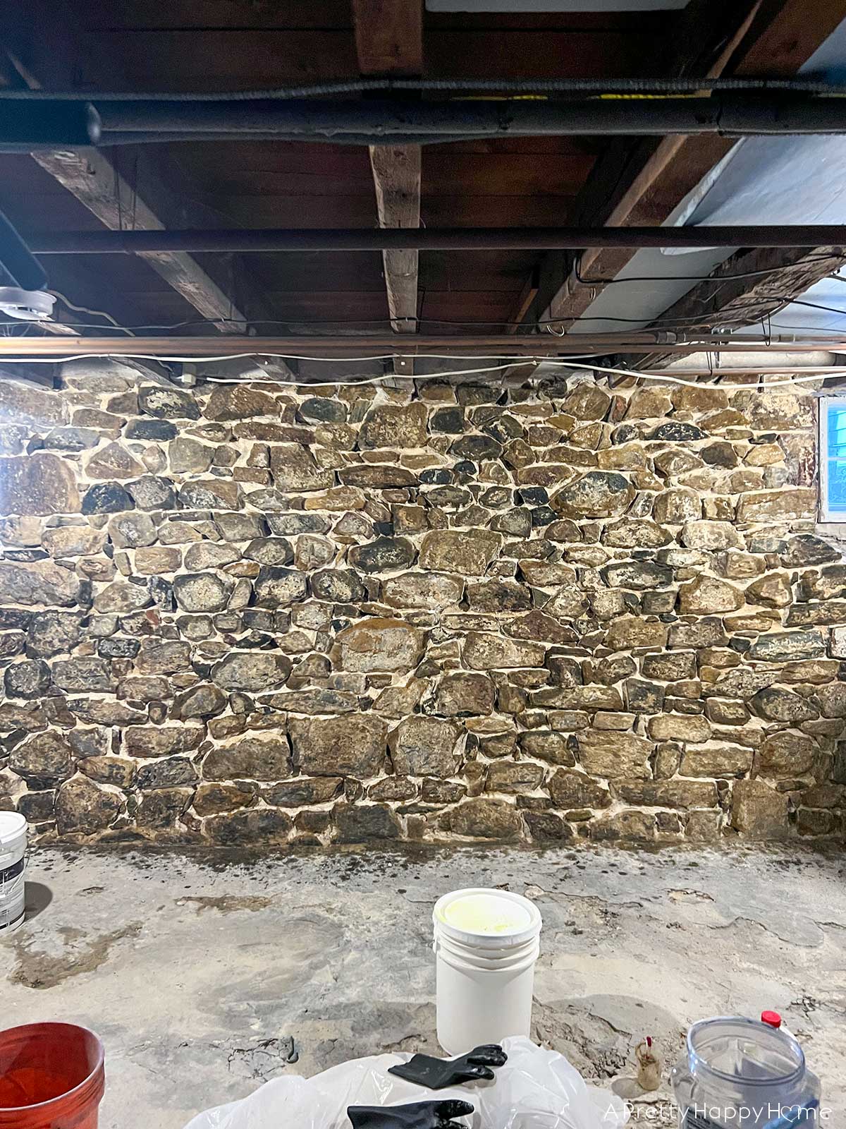 Wood In a Stone Wall floor joists sitting on top of a stone basement foundation