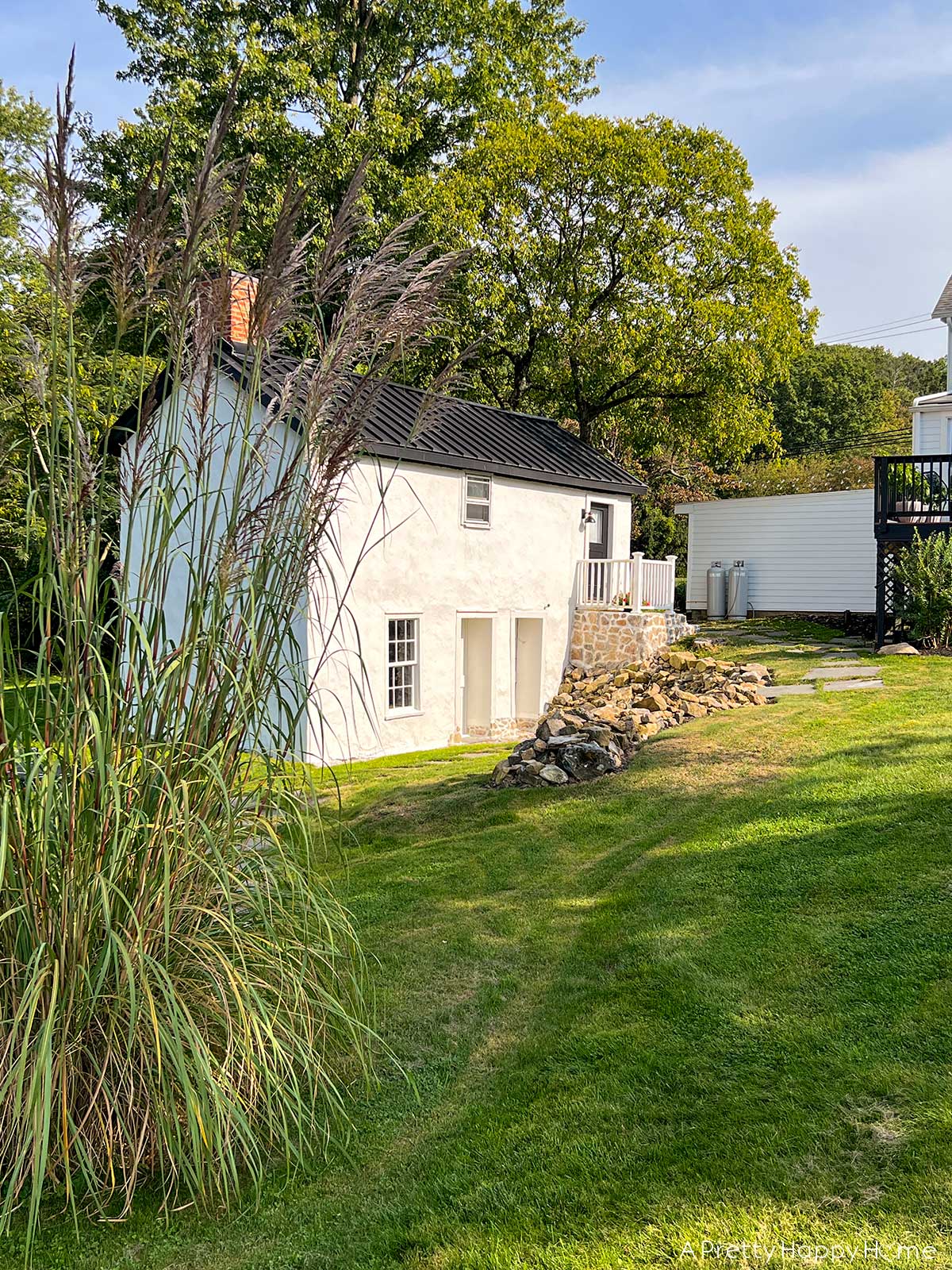 fieldstone porch made with fieldstone and lime mortar skimmed over concrete on a 250-year-old carriage house