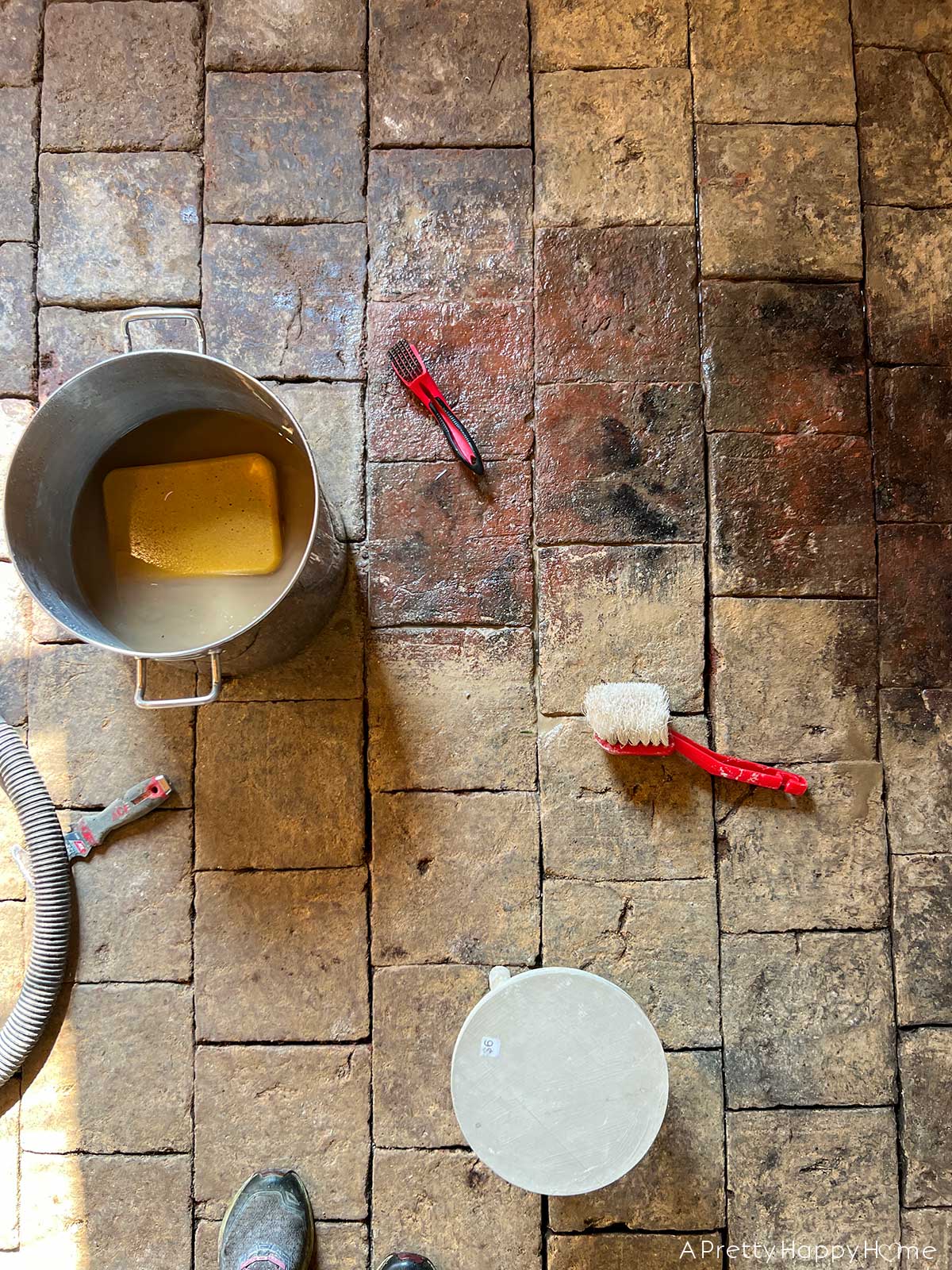 250 year old carriage house terracotta floor tiles hidden under dirt and revealed by scrubbing with water