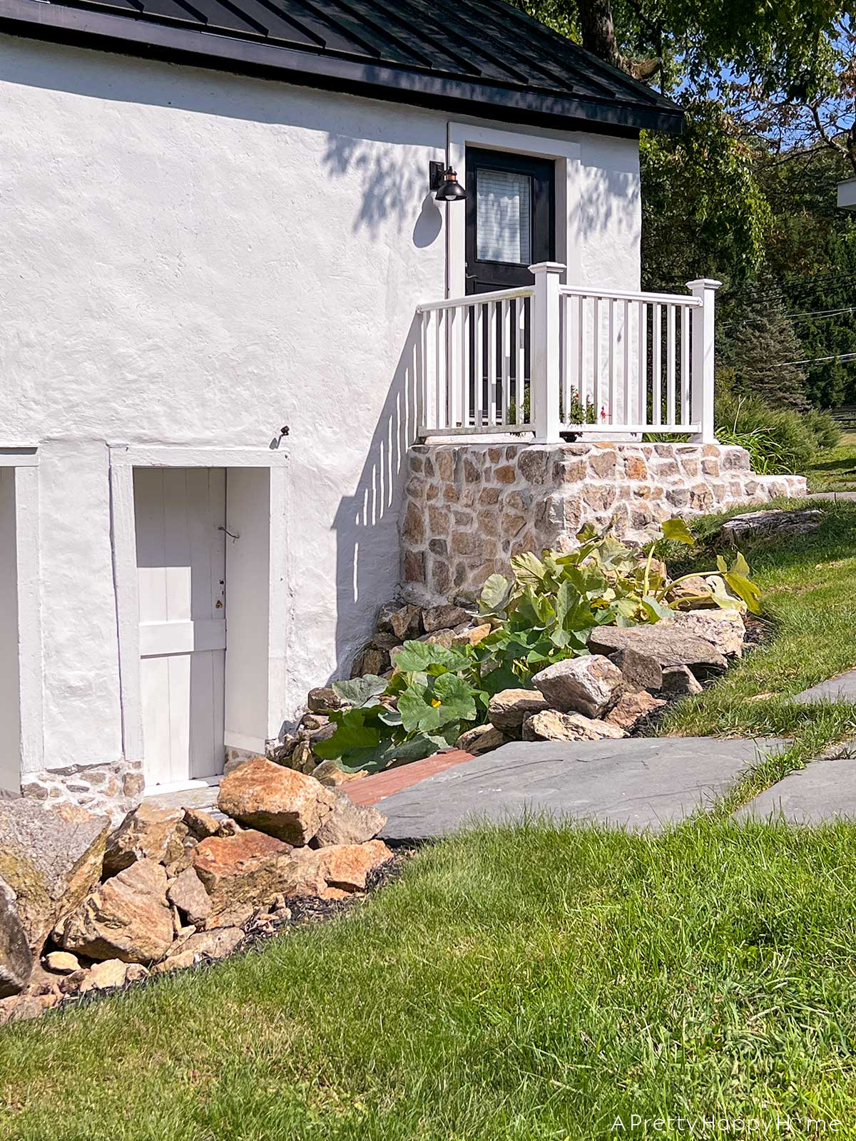 fieldstone porch made with fieldstone and lime mortar skimmed over concrete on a 250-year-old carriage house