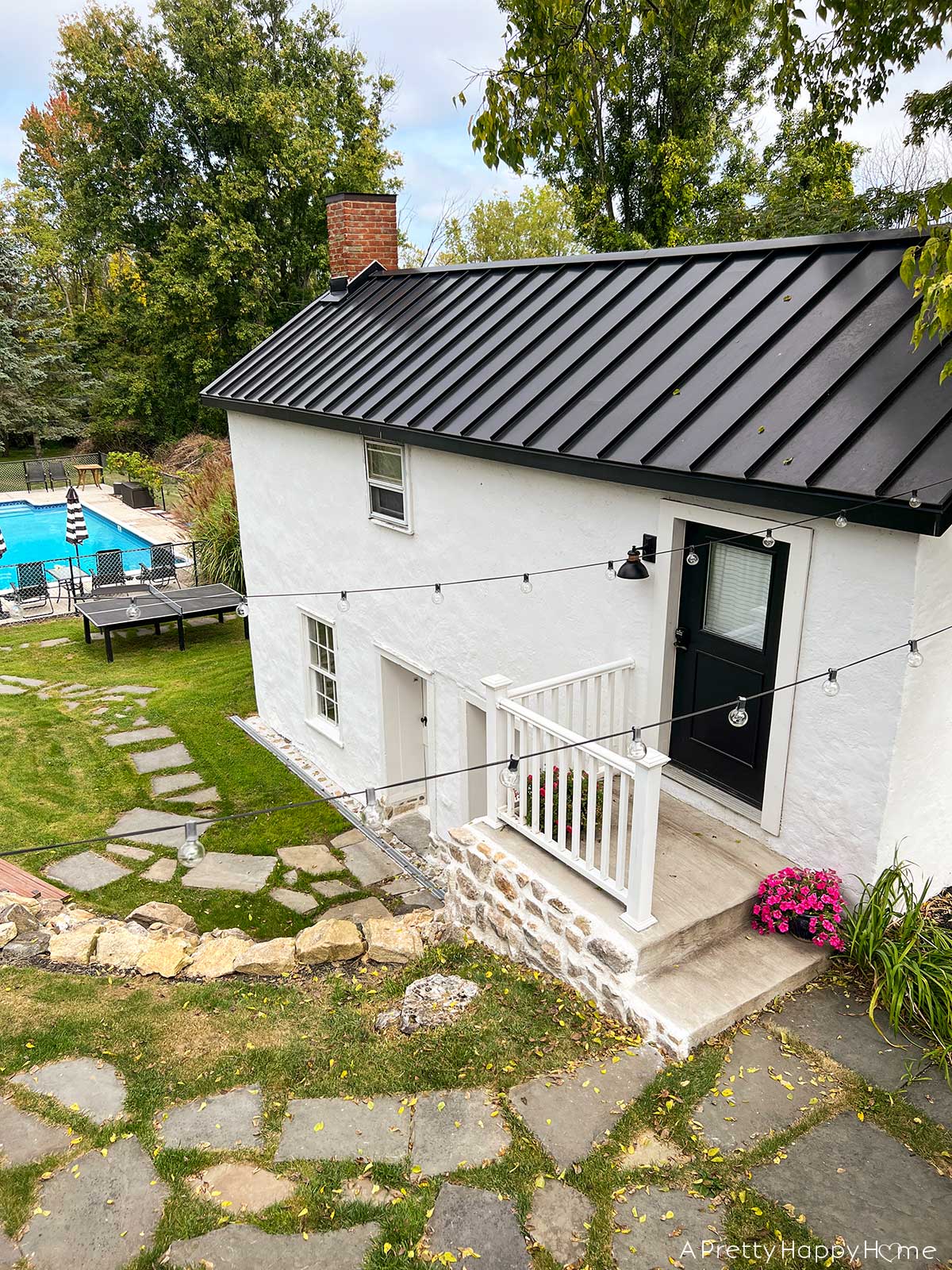 fieldstone porch made with fieldstone and lime mortar skimmed over concrete on a 250-year-old carriage house