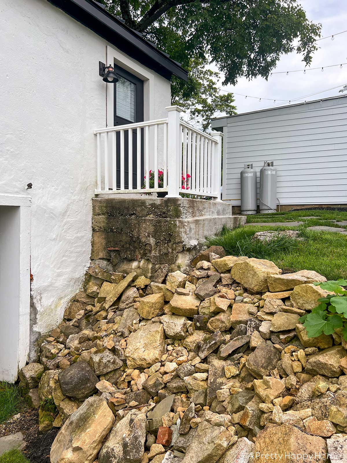 fieldstone porch made with fieldstone and lime mortar skimmed over concrete on a 250-year-old carriage house