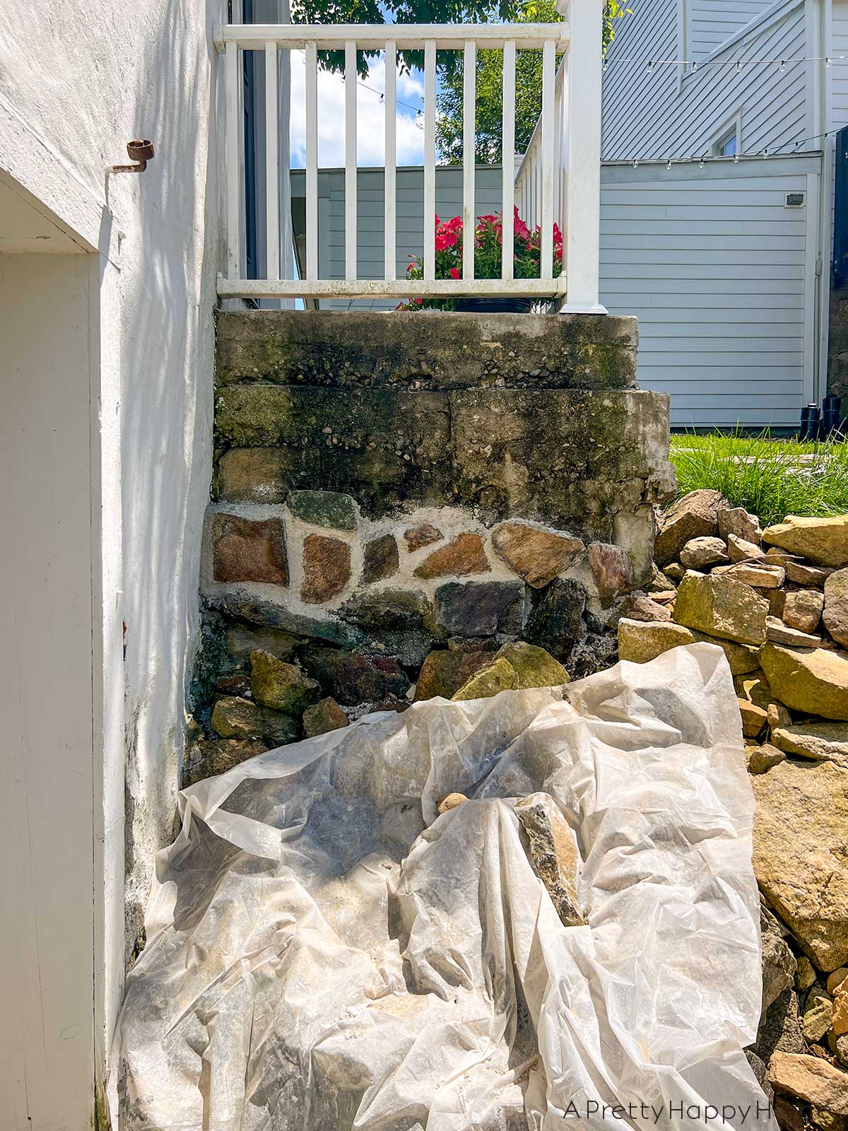 fieldstone porch made with fieldstone and lime mortar skimmed over concrete on a 250-year-old carriage house