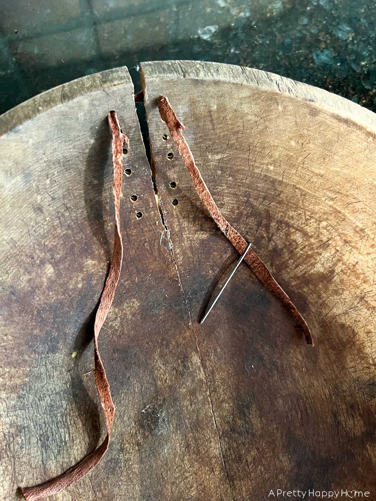 creative way to fix a cracked wood bowl with leather laces 