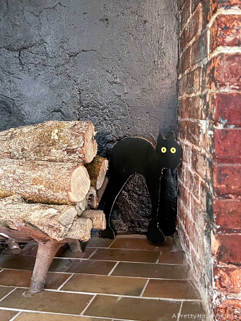 black scared cat cut out of cardboard for cheap halloween decor