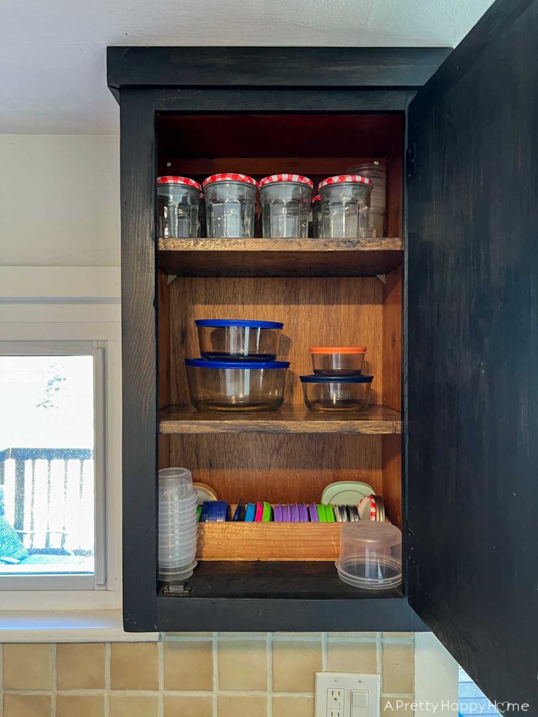 How I Styled My Latest Thrift Store Finds pyrex bowls organized in a kitchen cupboard