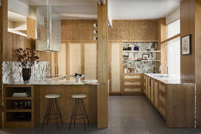 heidi gardner's kitchen with mirrored range hood photographed by nate sheets for architectural digest on the happy list