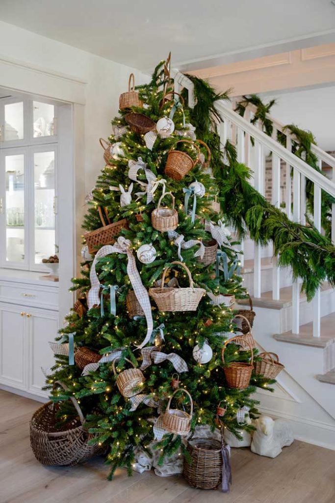 small baskets hung on a christmas tree from my little white barn via farmhouse living on the happy list