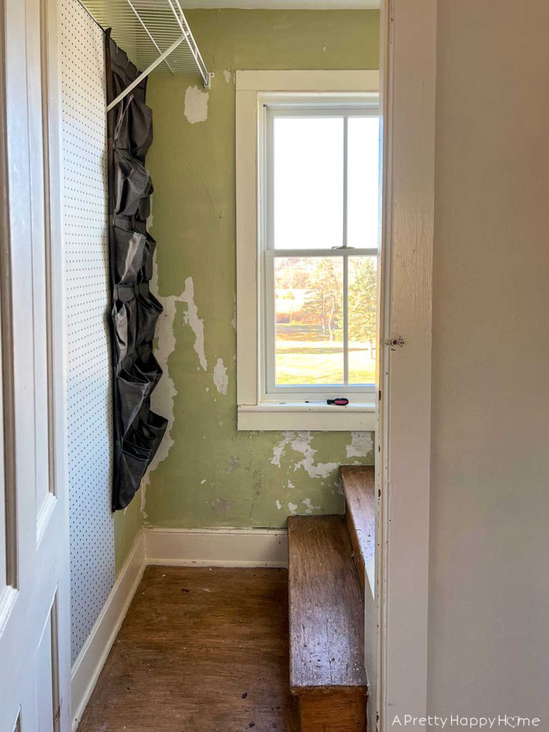 BEFORE photo of a wallpapered stairwell in a old 1700s farmhouse