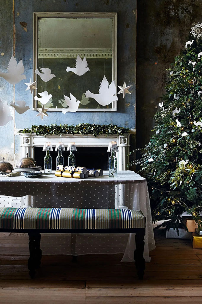 rachel whiting for house and garden uk hanging paper doves in front of a blue wall for christmas on the happy list