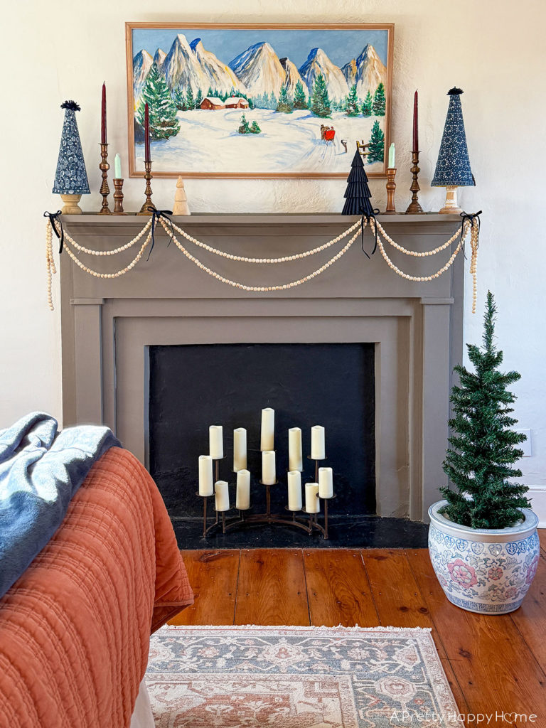 Three Christmas Fireplaces grey fireplace decorated with winter painting and blue christmas trees