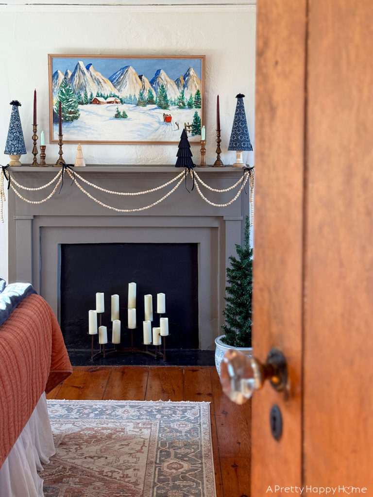 Three Christmas Fireplaces grey fireplace decorated with winter painting and blue christmas trees