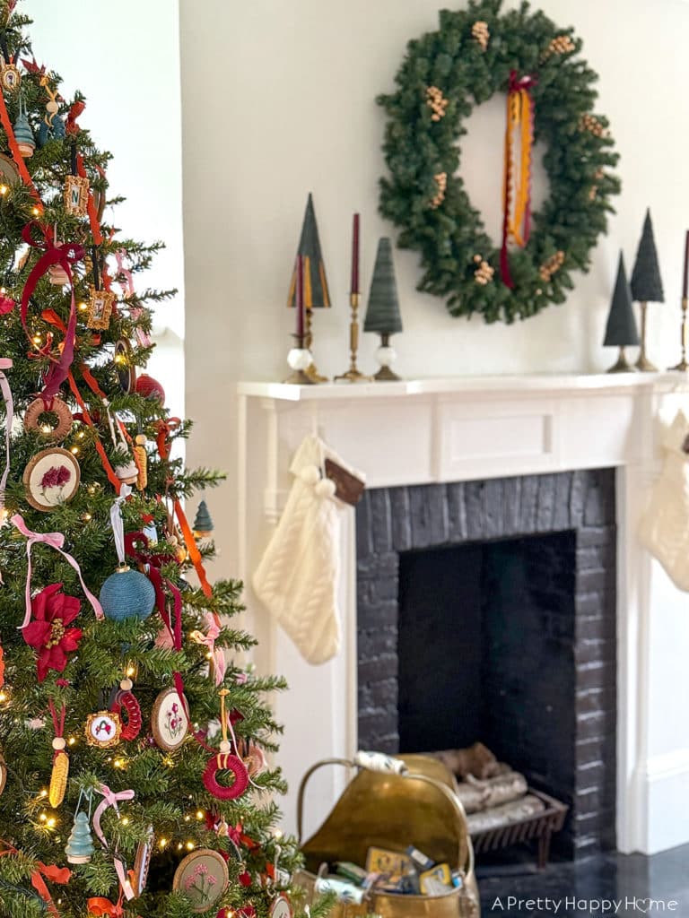 Three Christmas Fireplaces fireplace decorated with wreath and green christmas trees