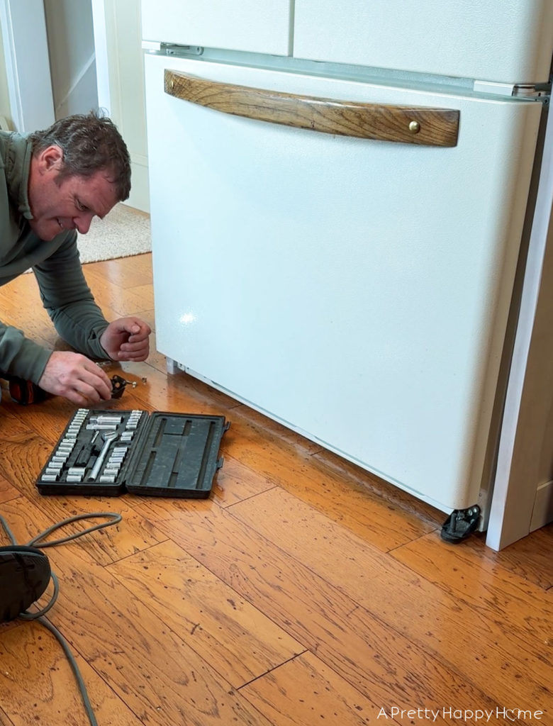 Building In Our Fridge: Four Ways To Customize A Fridge shaker style cabinet around fridge using tongue and groove construction. remove plastic grate at bottom of fridge and add feet to bottom of fridge