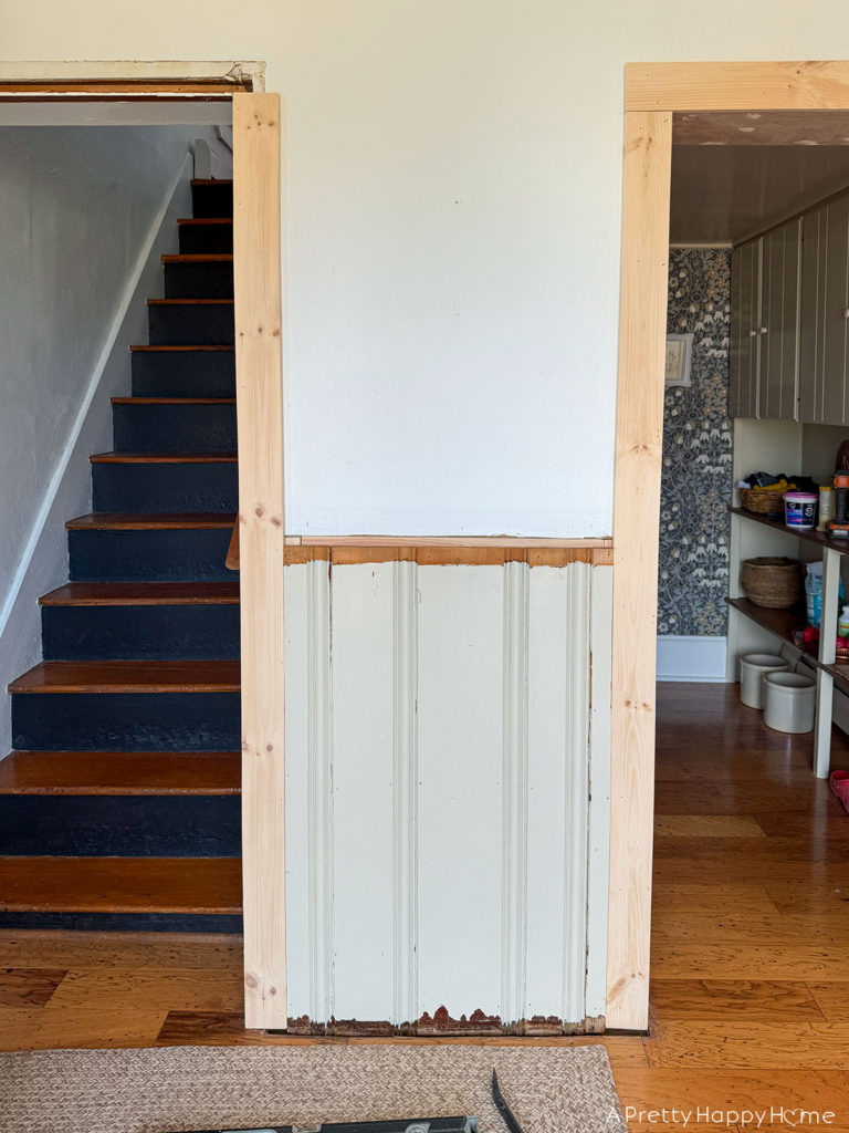 Building In Our Fridge: The Prep Work Is What Gets You repairing trim and wainscoting in a farmhouse with black staircase