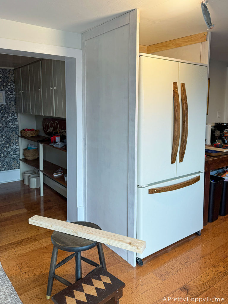 Building In Our Fridge: Four Ways To Customize A Fridge shaker style cabinet around fridge using tongue and groove construction. remove plastic hinge covers on top of fridge and make new wood hinge cover