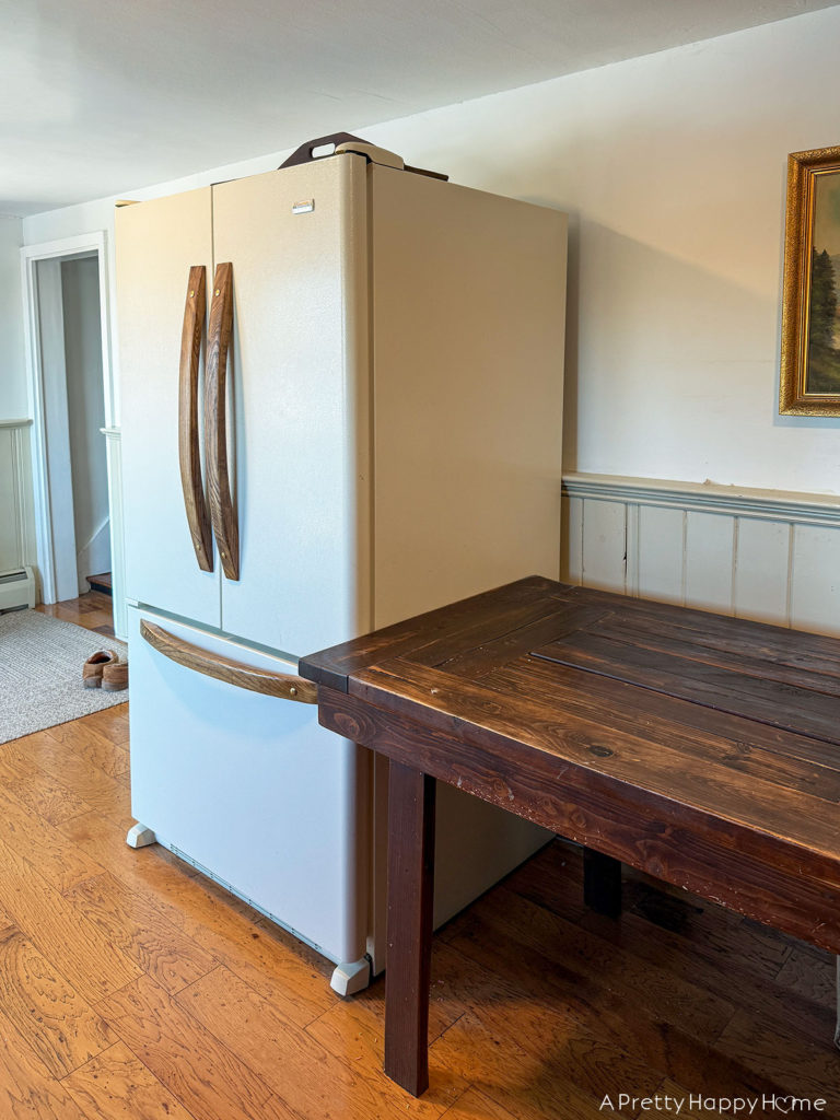 building in a fridge to make it look custom and panel ready fridge with wood handles