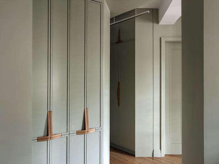 custom wood handles on green cabinets via remodelista photography by Matthew Williams | design by Workstead and Rosario Candela