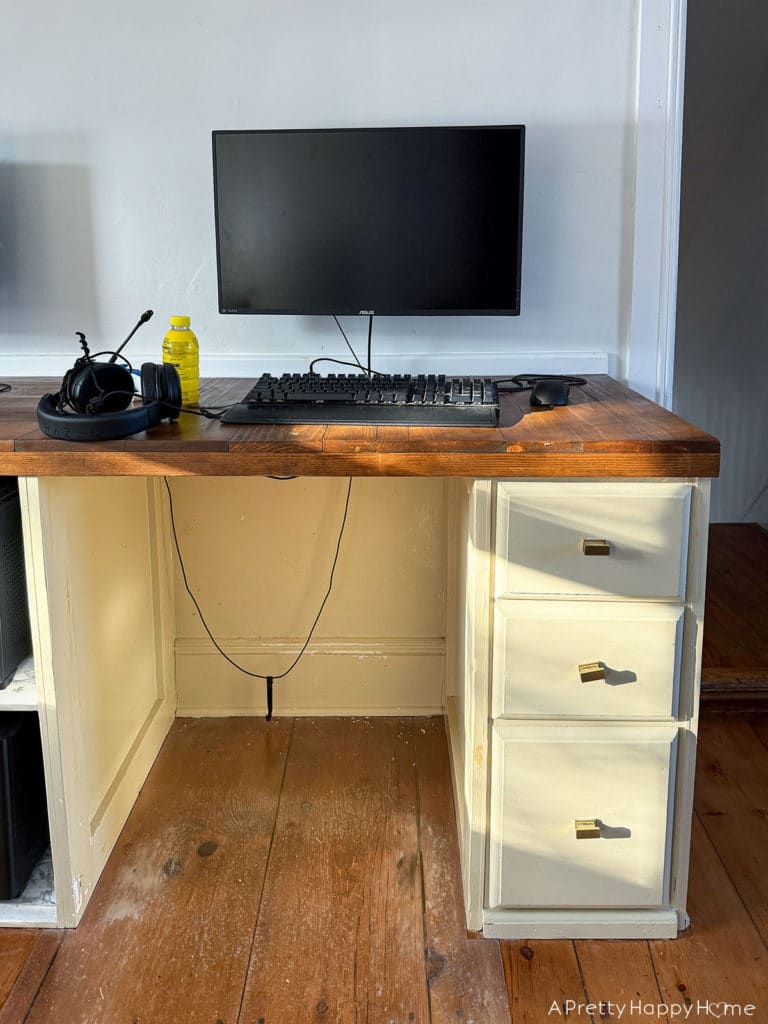 BEFORE DIY Copper Toe Kick For Built-In Desks to solve the problem of feet scuffing the trim using adhesive copper toe kick cut with metal snips