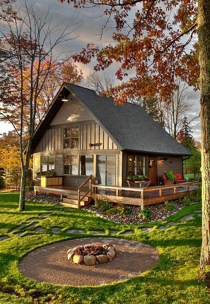 platte lake tiny house with bench on deck design by Lands End Development featured at town and country living on the happy list