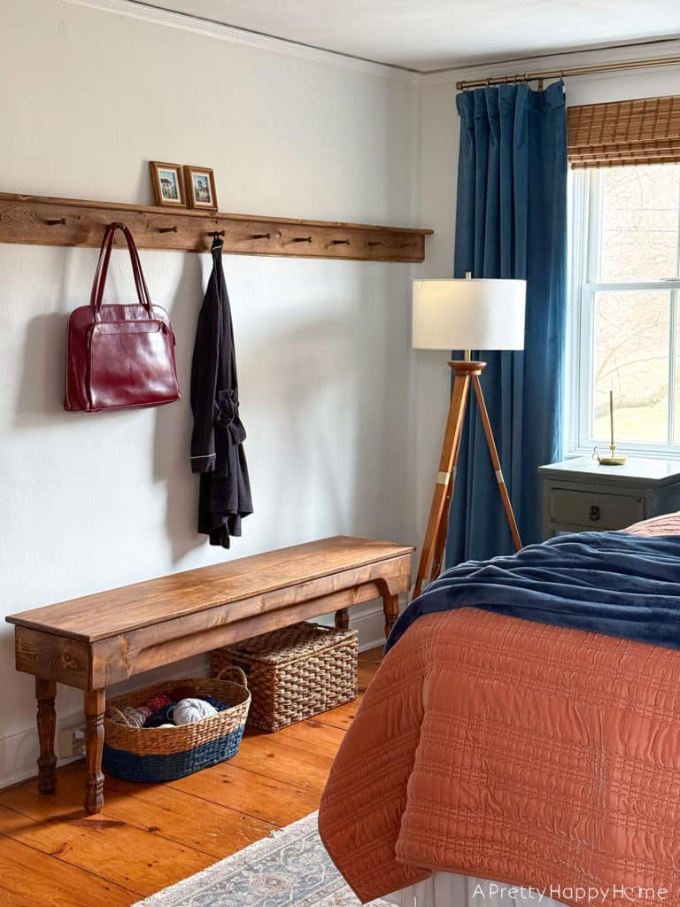 bedroom peg rail over a bench in a colonial farmhouse