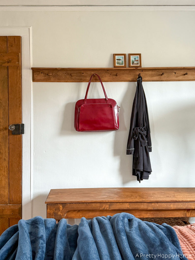 bedroom peg rail over a bench in a colonial farmhouse