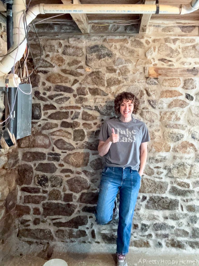 repointing a stone wall with old pipes embedded in the wall Stone Carriage House Gym: Part 4 