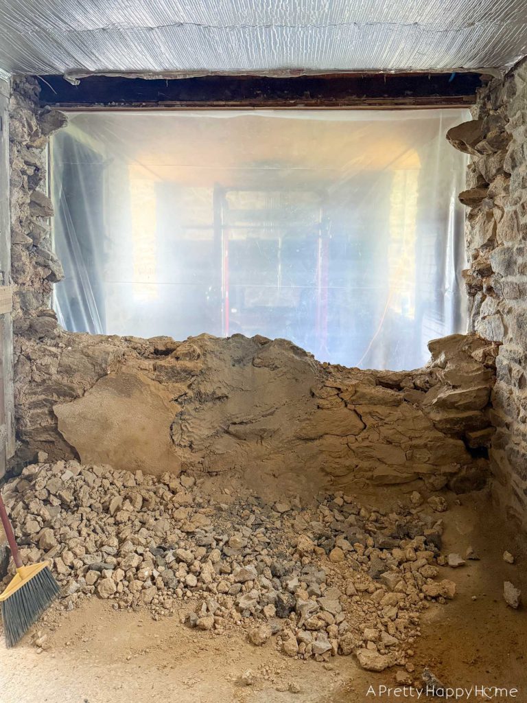 stone carriage house gym expansion removing a stone wall in an old building and repairing the floor underneath with concrete