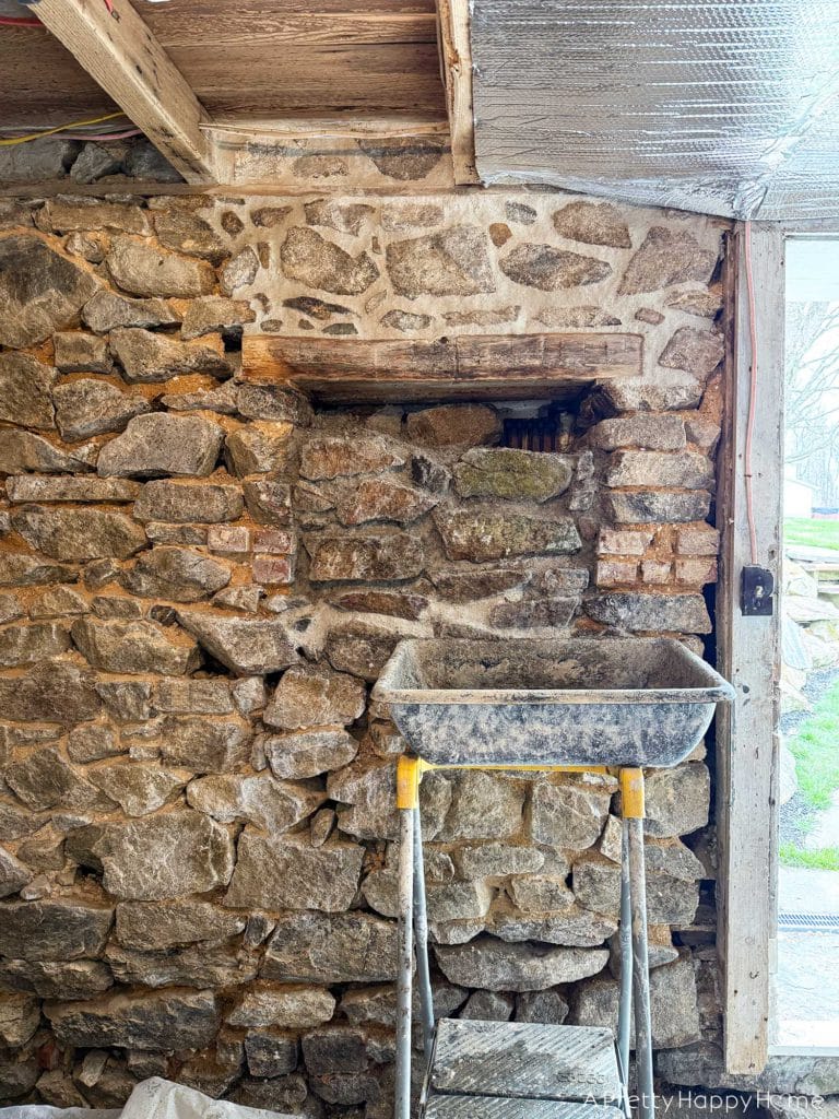 Stone Carriage House Gym Old Windows field stone foundation with old abandoned window filling in window area with fieldstone and lime mortar