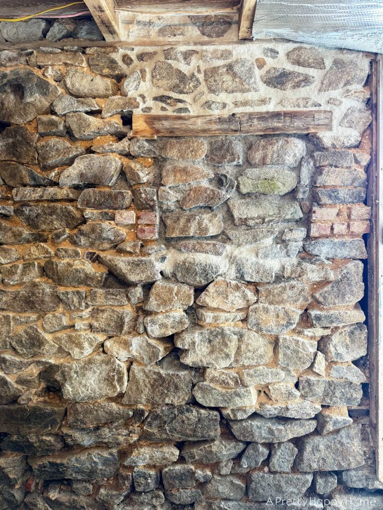 Stone Carriage House Gym Old Windows field stone foundation with old abandoned window filling in window area with fieldstone and lime mortar