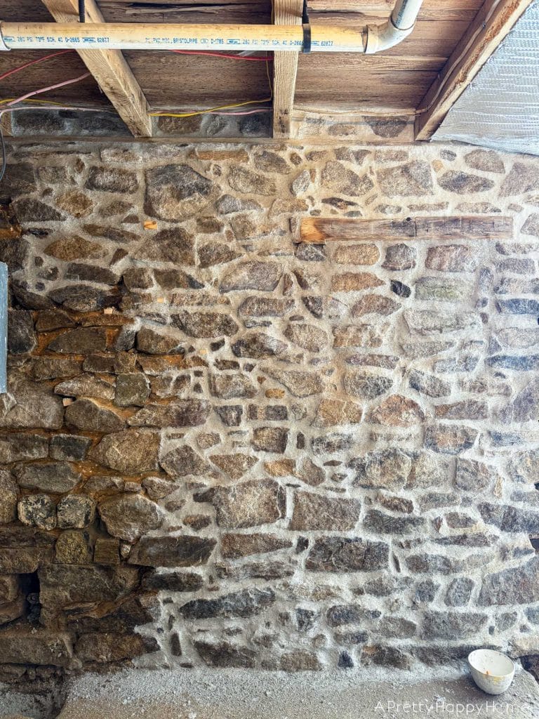 Stone Carriage House Gym Old Windows field stone foundation with old abandoned window filling in window area with fieldstone and lime mortar