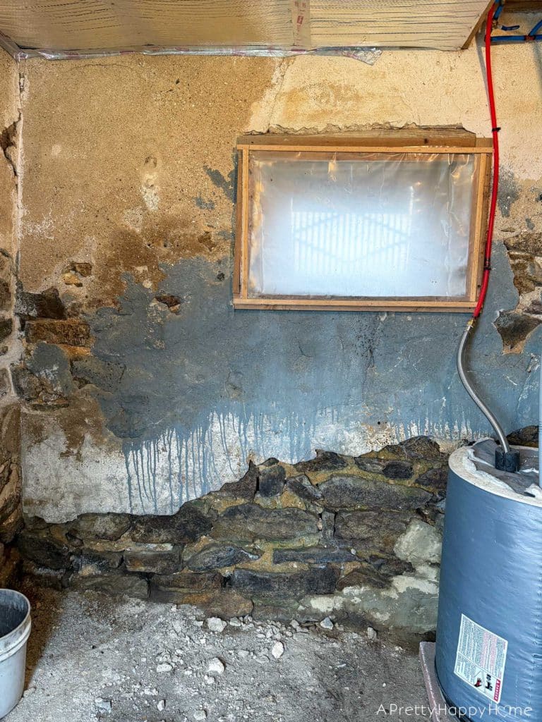 Stone Carriage House Gym Old Windows field stone foundation with old abandoned window covered in plastic