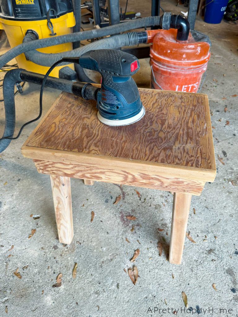 BEFORE farmhouse style plywood side table stained with paint dipped legs in black