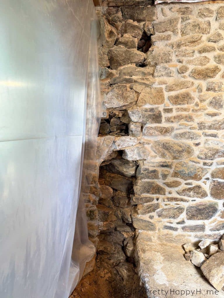 stone carriage house gym expansion removing a stone wall in an old building and repairing the floor underneath with concrete
