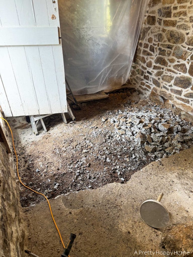 stone carriage house gym expansion removing a stone wall in an old building and repairing the floor underneath with concrete