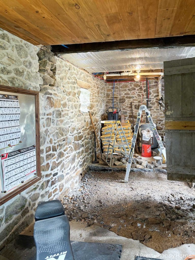 stone carriage house gym expansion removing a stone wall in an old building and repairing the floor underneath with concrete