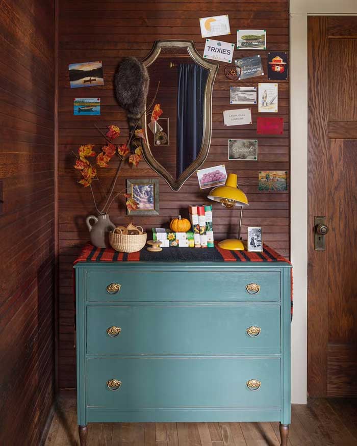 souvenir postcards displayed on a cabin wall in wisconsin Marta Xochilt Perez for Country Living on the happy list