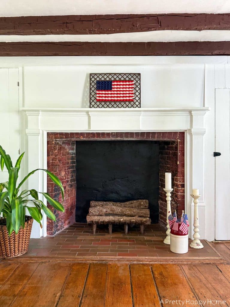 Woven American Flag on an Antique Grate in a colonial era farmhouse flag is woven with red white and blue yarn