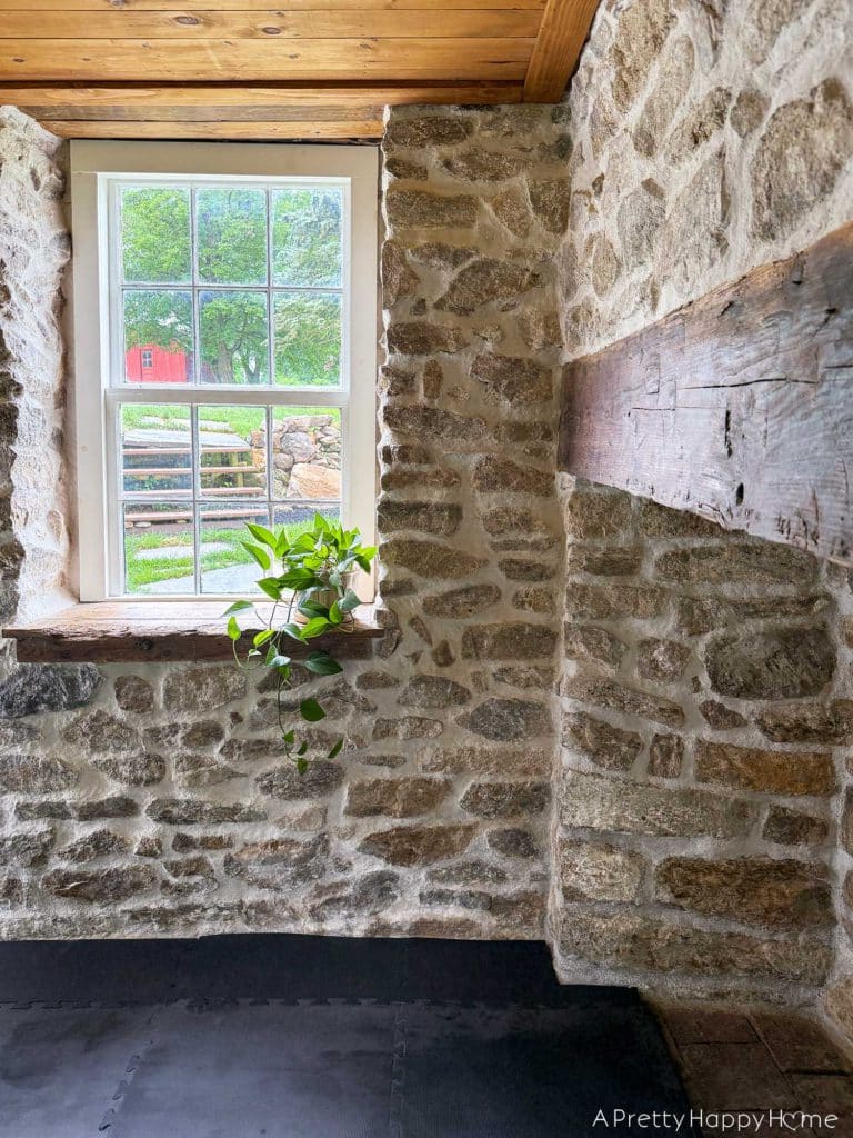 stone carriage house gym expansion home gym with stone walls and wood ceiling
