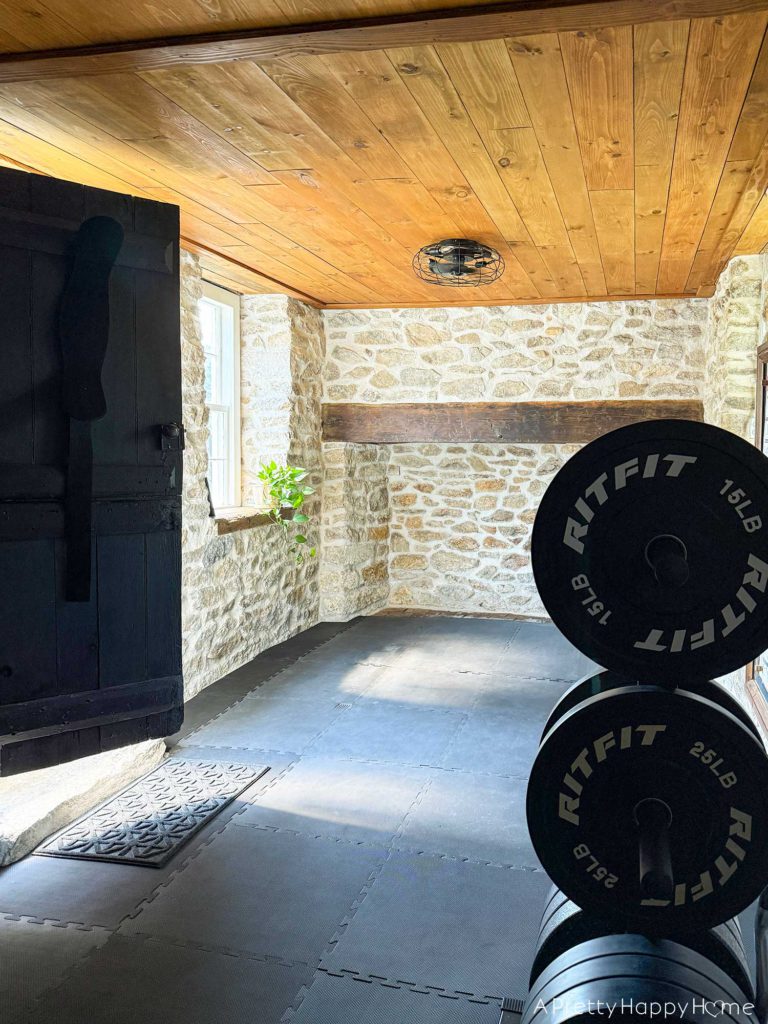 stone carriage house gym expansion home gym with stone walls and wood ceiling