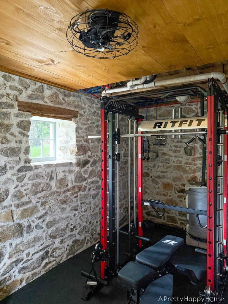 stone carriage house gym expansion home gym with stone walls and wood ceiling
