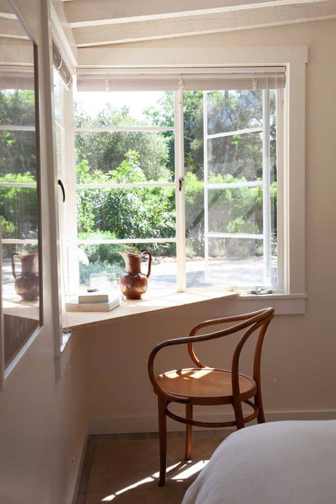 kathleen whitaker montecito cottage photo by logan white for remodelista on the happy list plywood corner desk between two corner windows